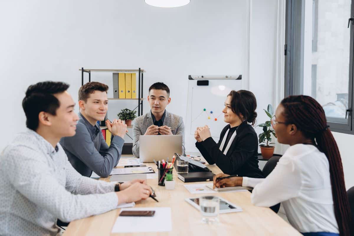 Group of multicultural businesspeople listening their boss speec